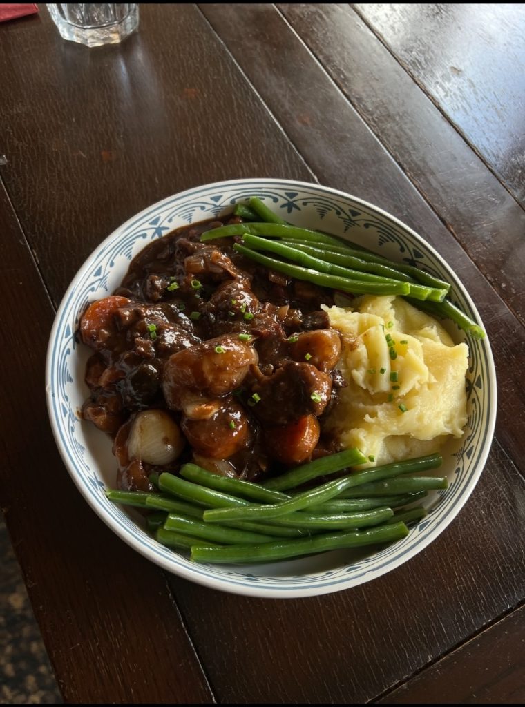 Beef bourguignon, cooked and plated